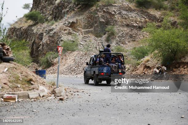 Fighters of the Houthi group riding a military vehicle while patrolling at AL-Khamseen street, which leads to the center of Taiz city amid a...