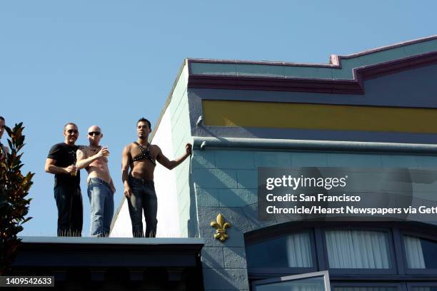 Festivalgoers watch the happenings at the Folsom Street Fair from a rooftop. Thousands attended the 25th anniversary Folsom Street Fair in San...