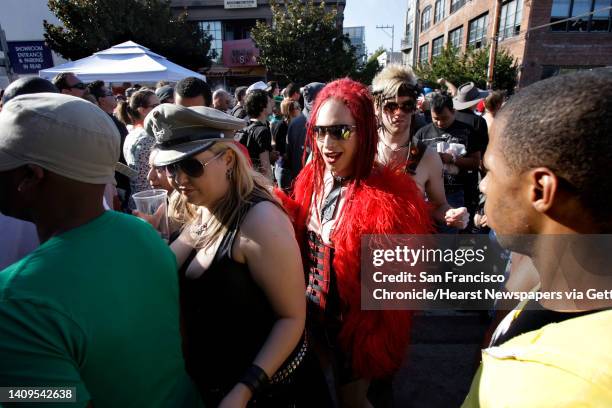 Adrian Roberts, center, and his wife, Deidre Roberts, make their way through the crowd at the Folsom Street Fair.