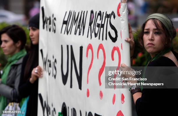 Pro Human Rights Signs Protesters hold a sign demanding human rights and the intervention of ...
