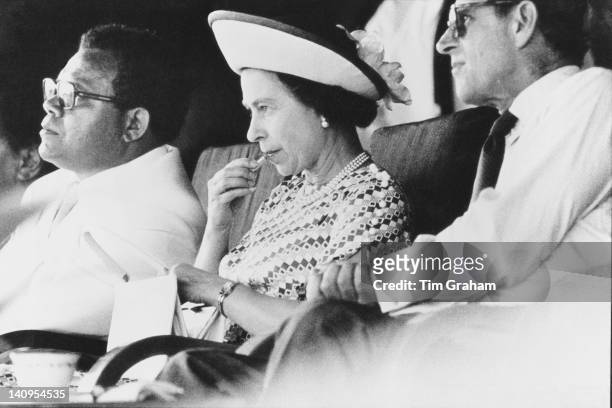 Queen Elizabeth II applies her lipstick at a function during a visit to Fiji with Prince Philip , February 1977.