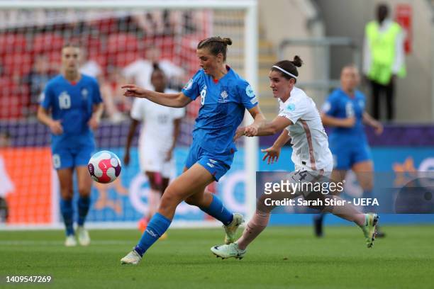Karolina Lea Vilhjalmsdottir of Iceland is challenged by Charlotte Bilbault of France during the UEFA Women's Euro 2022 group D match between Iceland...