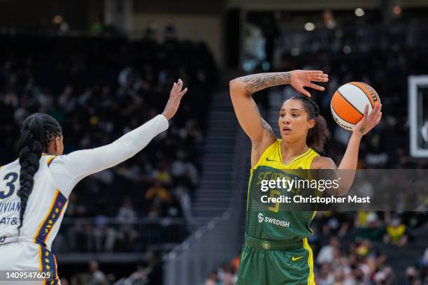 Gabby Williams of the Seattle Storm looks to make a pass while being guarded by Victoria Vivians of the Indiana Fever during the second half of a...