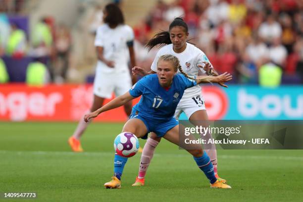 Agla Maria Albertsdottir of Iceland holds off Selma Bacha of France during the UEFA Women's Euro 2022 group D match between Iceland and France at The...