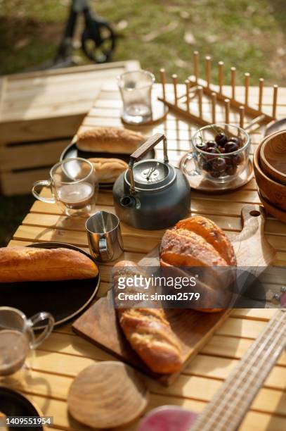 continental breakfast on the picnic table. weekend morning concept. - sunny backyard stock pictures, royalty-free photos & images