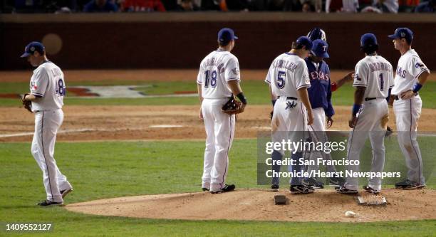 Rangers' Colby Lewis is taken out of the game in the eigth inning after giving up homerun and hitting Aubrey Huff with a pitch during game 3 of the...