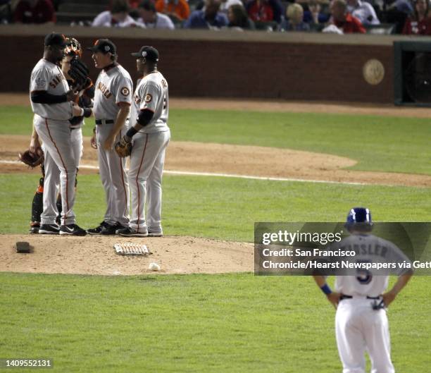 Pitching coach Dave Rightti visits Guillermo Mota in the sixth inning during game 3 of the 2010 World Series between the San Francisco Giants and the...