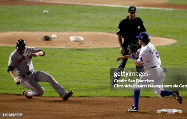 San Francisco Giants first baseman Aubrey Huff is out at second as Texas Rangers second baseman Ian Kinsler completes the double play in the fifth...