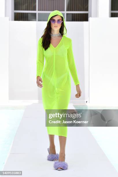 Model walks the runway wearing Madeline Cary with Modern Natured during Flying Solo Miami Swim Week 2022 on July 18, 2022 in Miami Beach, Florida.