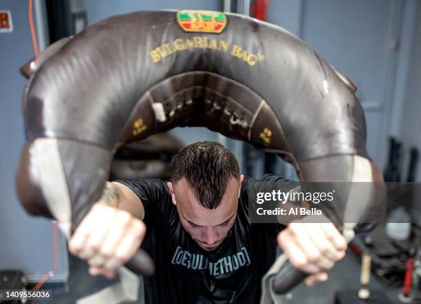 Thomas De Giuli swings a Bulgarian bag during a workout at the Strength Factory gym during a workout at the Strength Factory gym on July 18, 2022 in...