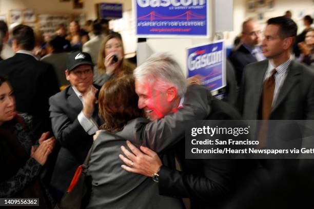George Gascon gets a hug from a supporter as he comes out to address the crowd gathered for election results at Delancey Street Foundation in San...