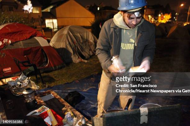 Aaron Thomas of Oakland prepares some food for Occupy Oakland campers at a new camp at 18th and Linden Streets. A small group of about 30 Occupy...