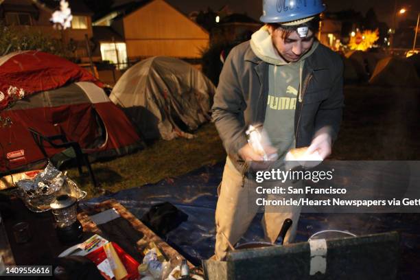 Aaron Thomas of Oakland prepares some food for Occupy Oakland campers at a new camp at 18th and Linden Streets. A small group of about 30 Occupy...