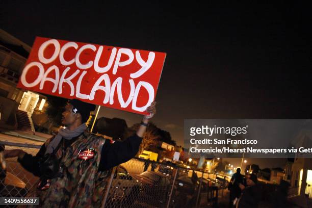 Melvin Keley holds the Occupy Oakland sign at the group's new camp at 18th and Linden Streets. A small group of about 30 Occupy Oakland protesters...