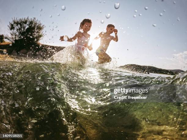 kids playing in the sea - macedonia greece stock pictures, royalty-free photos & images