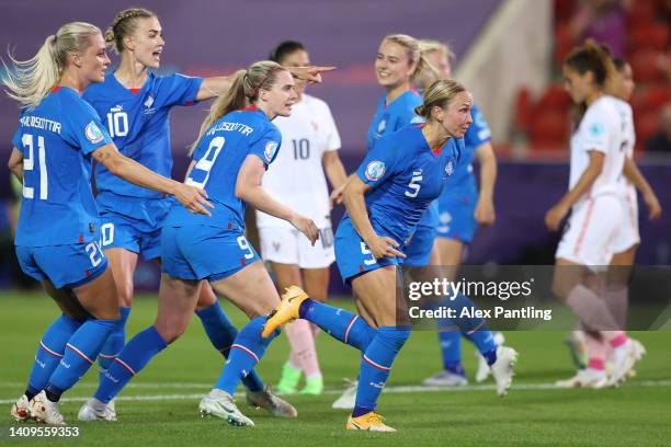 Dagny Brynjarsdottir of Iceland indicates to teammates to collect the ball from the net after scoring their side's first goal from the penalty spot...