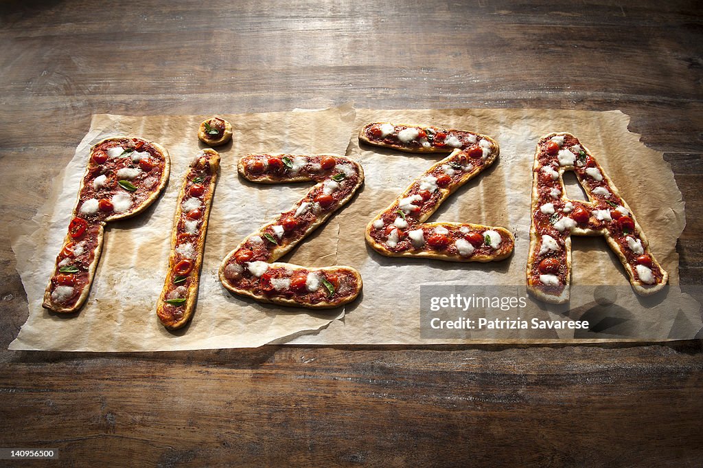 Freshly made Pizza spelling out the word 'pizza'