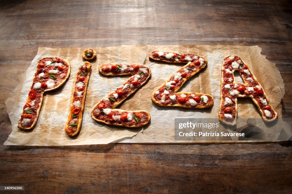 Freshly made Pizza spelling out the word 'pizza'