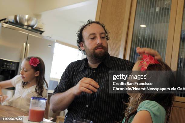 Joshua Safran with his daughters, Sivan right, and Ketriel left, at their Oakland, Calif., home on Sunday, August 18, 2013. Safran has written a...