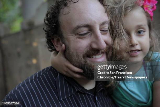 Joshua Safran with his daughter Sivan at their Oakland, Calif., home on Sunday, August 18, 2013. Safran has written a memoir about growing up off the...