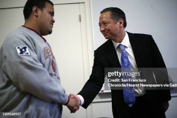 Jeff Adachi, SF public defender, shakes hands with Robert at Lincoln High School in San Francisco, Calif., on Tuesday, March 4, 2014. Through the...