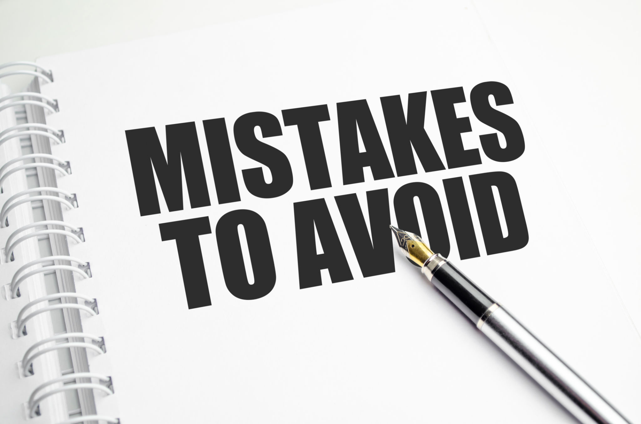 Mistakes word message on white paper book and copy space on white desk Mistakes word message on white paper book and copy space on white desk
