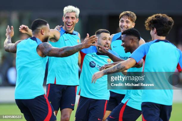 Sergi Roberto and Jordi Alba of FC Barcelona interact with their teammates during a training session ahead of the preseason friendly against Inter...