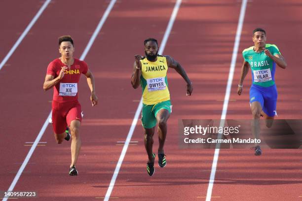 Zhenye Xie of Team China, Rasheed Dwyer of Team Jamaica, and Lucas Vilar of Team Brazil compete in the Men's 200m heats on day four of the World...