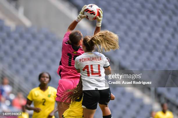 Rebecca Spencer of Jamaica jumps for the ball with Priscila Chinchilla of Costa Rica during the third place match between Costa Rica and Jamaica as...
