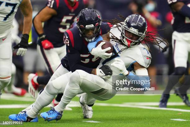Christian Kirksey of the Houston Texans tackles D'onta Foreman of the Tennessee Titans during an NFL game at NRG Stadium on January 09, 2022 in...