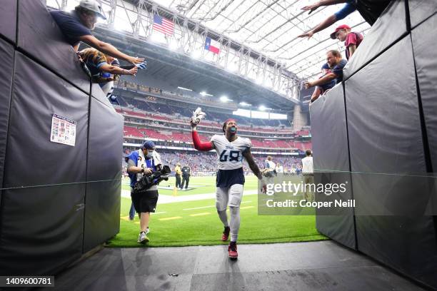 Bud Dupree of the Tennessee Titans runs off of the field against the Houston Texans after an NFL game at NRG Stadium on January 09, 2022 in Houston,...