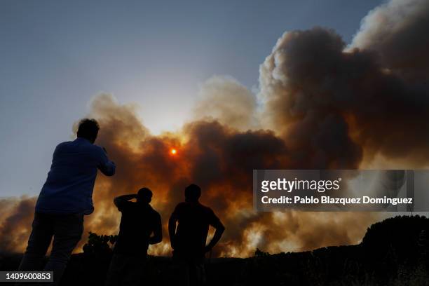 People watch a forest fire in Cebreros on July 18, 2022 in Avila, Spain. Wildfires have broken out across Spain and southern Europe amid a severe...