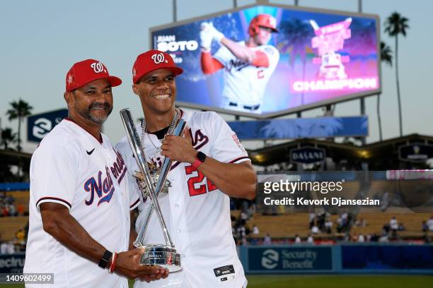 National League All-Star Juan Soto of the Washington Nationals and manager Dave Martinez pose with the 2022 T-Mobile Home Run Derby trophy after Soto...