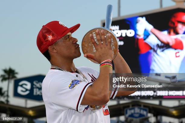 National League All-Star Juan Soto of the Washington Nationals poses with the 2022 T-Mobile Home Run Derby trophy after winning the event at Dodger...