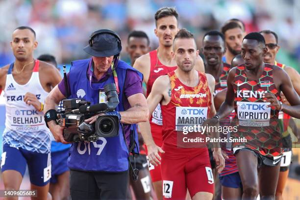 Athletes in the Men's 3000m Steeplechase Final run around a cameraman on day four of the World Athletics Championships Oregon22 at Hayward Field on...