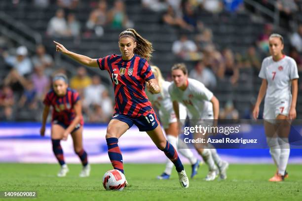 Alex Morgan of USA kicks the ball to score her team's first goal through a penalty during the championship match between United States and Canada as...