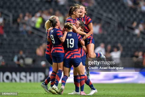 Alex Morgan of USA celebrates with teammates after scoring her team's first goal during the championship match between United States and Canada as...