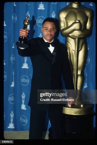 Cuba Gooding Jr holds his award for Best Performance By An Actor In A Supporting Role for "Jerry Maguire" at the 69th Annual Academy Awards ceremony...