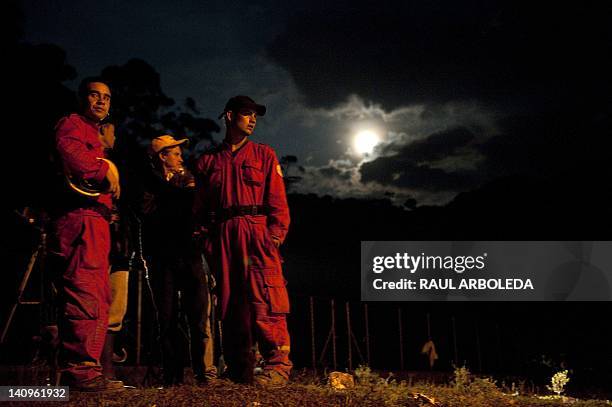 Rescue workers and relatives wait during the flood that ripped through a coal mine in the municipality of Angelopolis, Antioquia department, in...