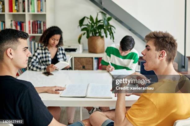 deaf friends doing homework together - hearing aids stock pictures, royalty-free photos & images