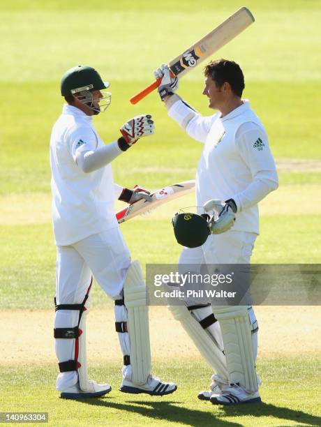 Graeme Smith of South Africa celebrates his century with Jacques Kallis during day three of the First Test match between New Zealand and South Africa...