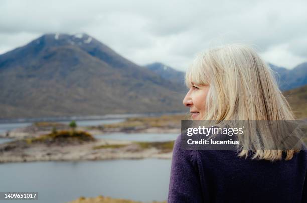 woman in tartan, scotland highlands - woman kilt stock pictures, royalty-free photos & images