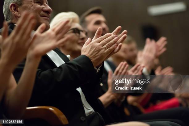 spectators clapping in the theater, focus on hands - awards ceremony 個照片及圖片檔