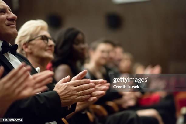 spectators clapping in the theater, focus on hands - clapping hands close up stockfoto's en -beelden