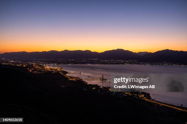 Pre-dawn light, looking North-East, over the heavily developed Gulf of Aqaba on July 18 in Eilat, Israel. Here the reef's most pristine and precious...
