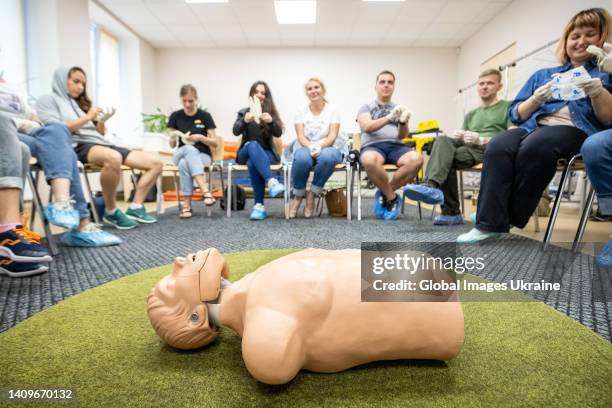 First aid mannequin doll lies in a circle of people that are preparing to practice at first aid class on July 11, 2022 in Kyiv, Ukraine. Under...