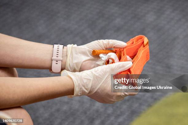 Participant holds a tourniquet during first aid class on July 11, 2022 in Kyiv, Ukraine. Under martial law and constant shelling, anyone with the...