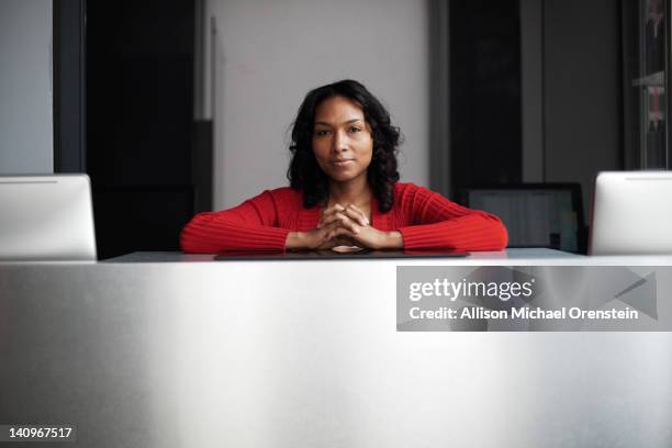 portrait of woman behind reception desk - reception stock-fotos und bilder