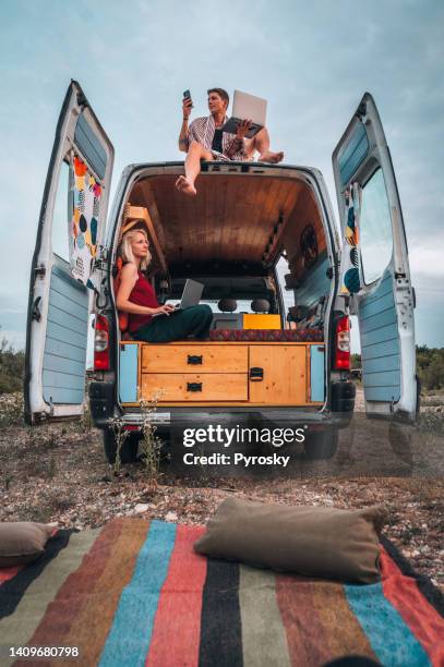 working remotely in their van - sitting on top of car stock pictures, royalty-free photos & images