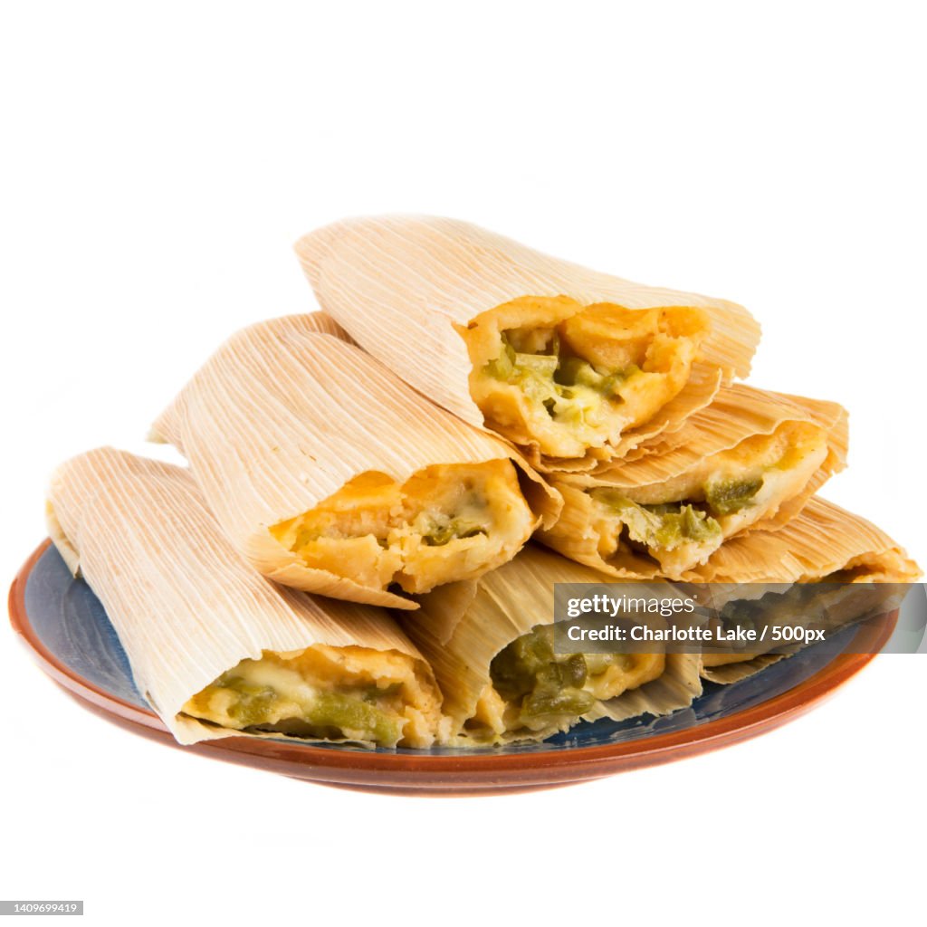 Close-up of food in plate against white background